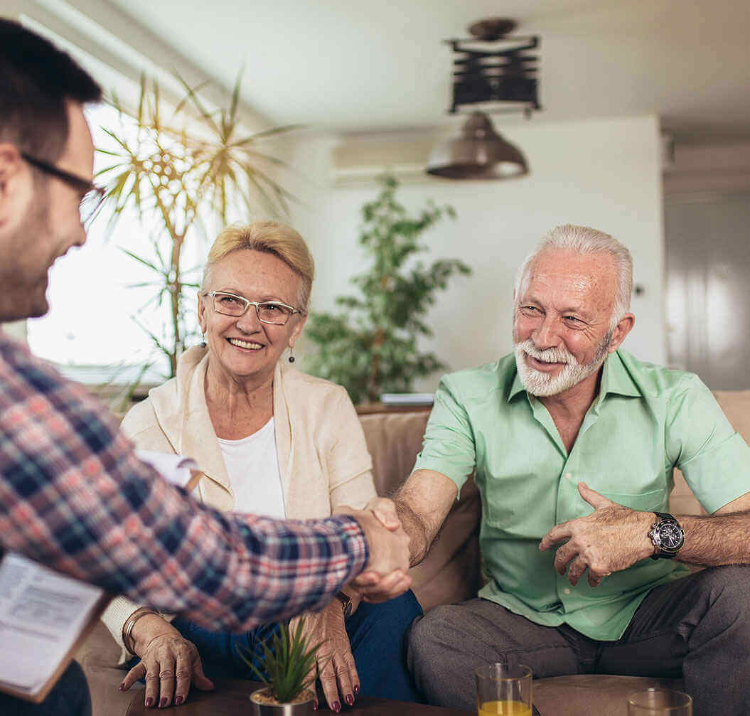 Positive aged couple consulting with insurance agent